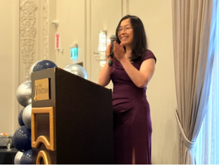 Cindy speaking at a podium